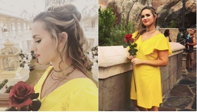 Kristen Mae posing in a yellow dress after an adult Princess makeover as princess Belle and holding ...