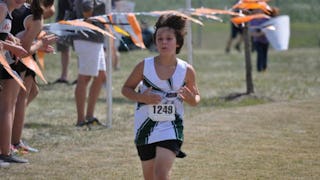 A boy running a marathon who is finishing last