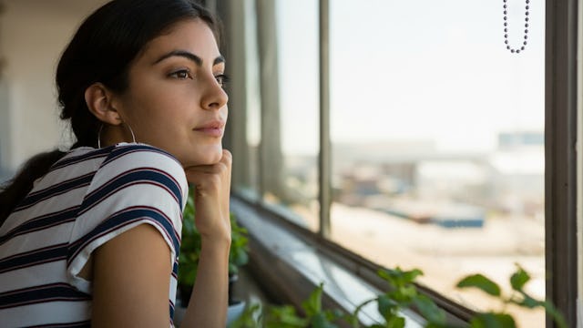 Girl distantly looking out the window and thinking after her father broke her heart