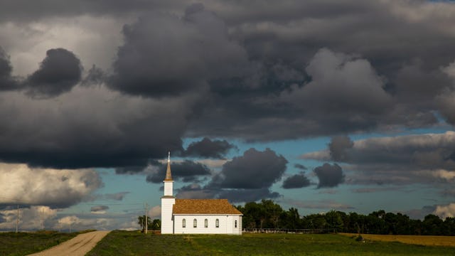 A church on slightly elevated terrain during a cloudy day
