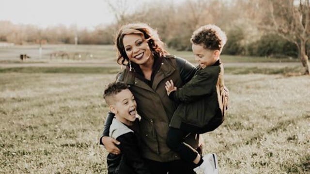 Mother posing with her two sons in the nature