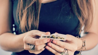 A mother smoking marijuana daily rolling a joint