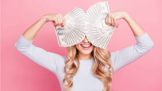 Woman with money symbolizing that money can't buy happiness
