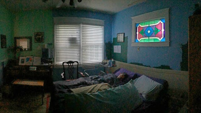 A messy sleeping room with green and blue walls in Brigid Kaelin mother's house