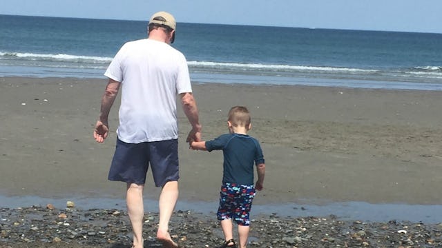 Deirdre Londergan's father-in-law and her son walking down a beach