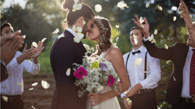 A married couple kissing on their wedding