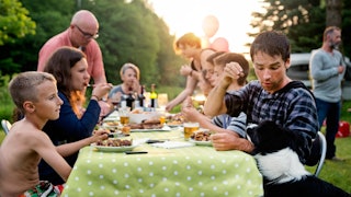 A  mother of eight and the rest of her family at an outdoor dinner gathering 