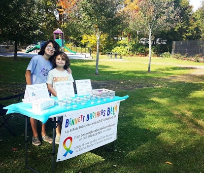 Two brothers at their "Bennet Brother Balm" stand selling lip balm to fight pediatric cancer