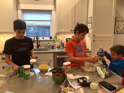  Three brothers in a kitchen preparing a meal 