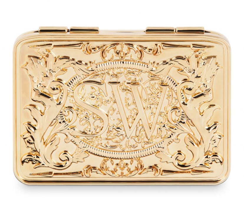 A golden decorated metal box with the initials SW for Snow White