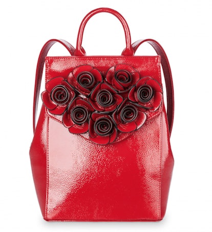A shiny red Belle backpack decorated with red leather roses