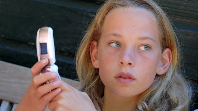 Teen girl with a flip phone