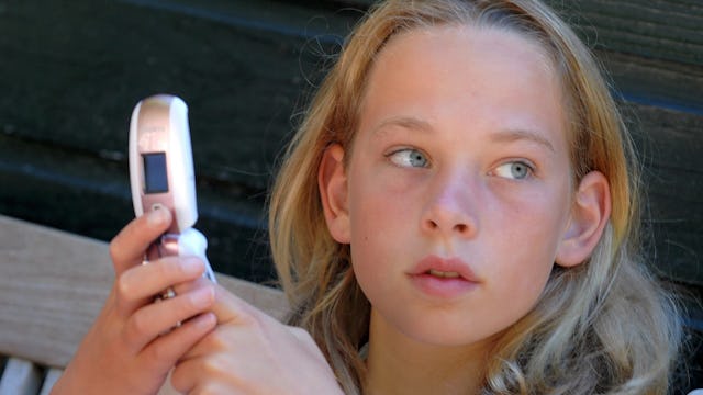 Teen girl with a flip phone 