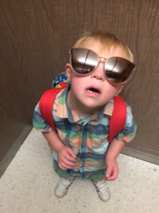 Bethann Craver's 4-year-old son with Down Syndrome standing with oversized sunglasses and a backpack