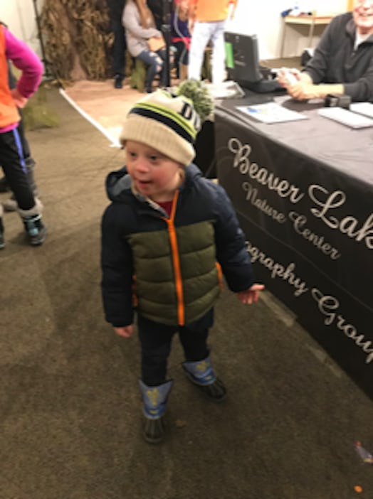 Bethann Craver's 4-year-old son with Down Syndrome in a green-navy jacket and a beige navy beanie