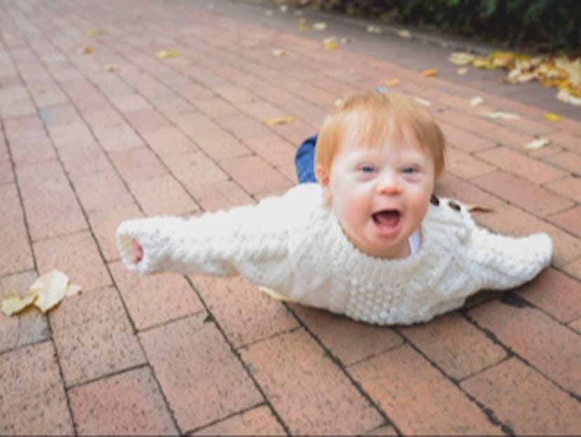 Bethann Craver's 4-year-old son with Down Syndrome lying stomach down in a park and smiling