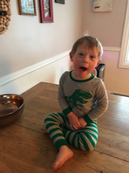 Bethann Craver's 4-year-old son with Down Syndrome sitting on a dining table