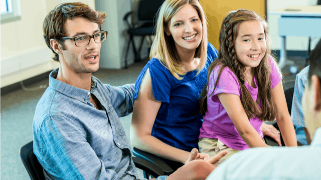 Parents with their tween daughter on an IEP meeting