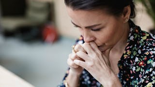 A woman being sad because she grew up with toxic parents