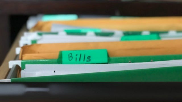 A green folder labeled as bills