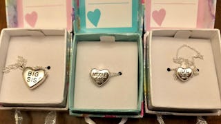 Three boxes with heart-shaped bracelet pendants