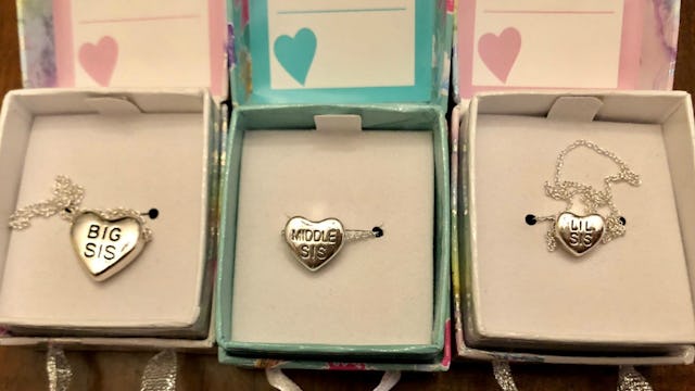 Three boxes with heart-shaped bracelet pendants