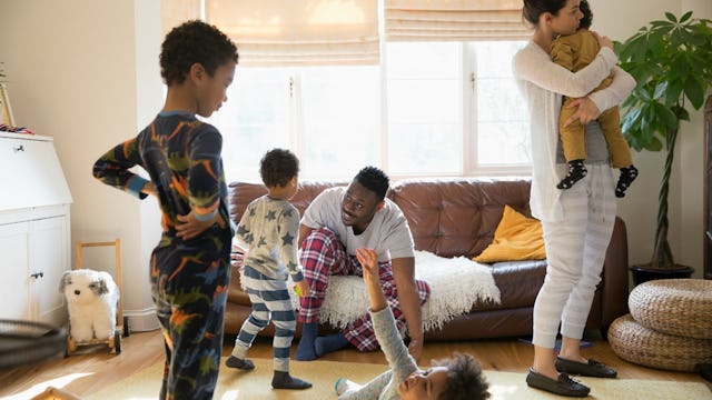 Parents playing with their 4 kids in a living room