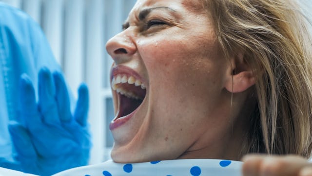 A woman screaming while going through labor