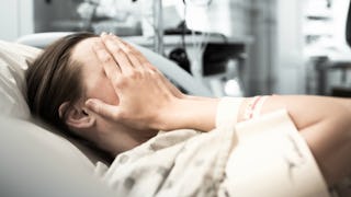 Pregnant woman lying down in a hospital bed