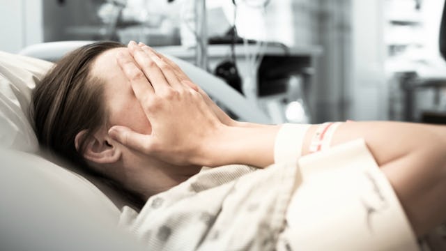 Pregnant woman lying down in a hospital bed