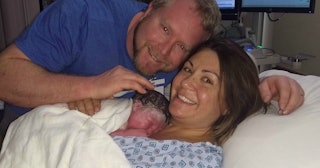 Husband and wife in hospital with their newborn baby