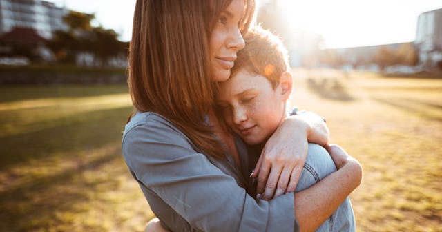 A mother huging her son and saying she is going to raise him right for the girls out there