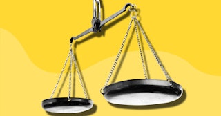 An old fashioned balance scale in front of a yellow background
