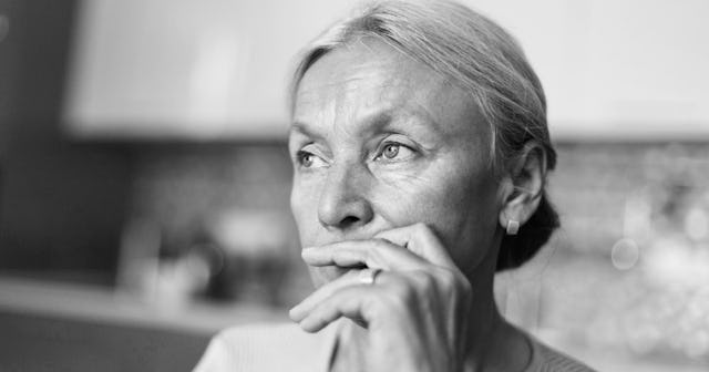 Closeup older woman being worried, in black and white picture filter