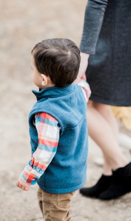 A mom holding her son's hand while walking