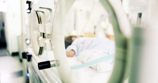 A baby lying down in the incubator after birth who has NEC