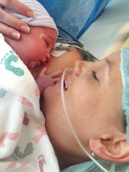 A mom with ppd holding her newborn baby in the hospital right after giving birth