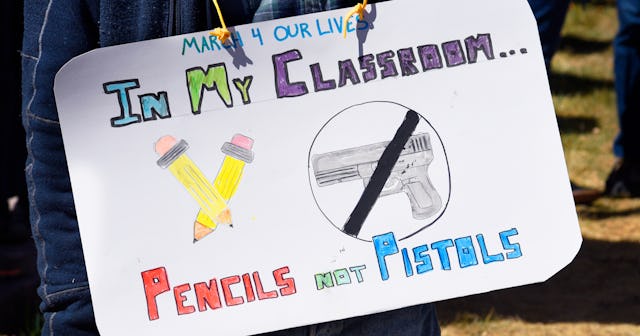 White board with text "In my classroom Pencils not Pistols" with pictures of pencils and a crossed o...