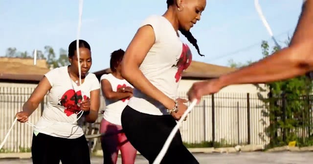 Four women from the 40+ Double Dutch Club exercising outside during a sunny day