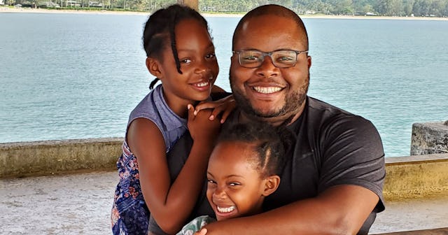 Dad posing with two kids on vacation