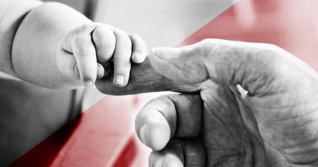 Little child grabbing dad's finger with its whole hand