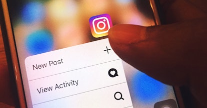 A phone with Instagram logo and the 'new post' and 'view activity' options open