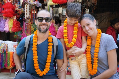 Parents and their autistic son wearing orange Hawaii leather necklaces