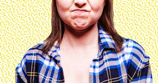 A barista woman in a blue-black-white checked shirt with an angry facial expression
