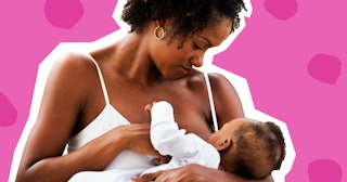 A woman in a white tank top breastfeeding her baby 