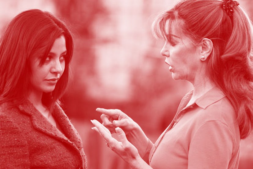 Two women talking, one is explaining something with a pink color filter