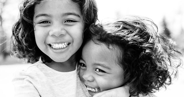Two sisters hugging and smiling