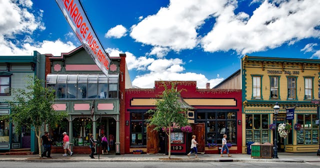 A town street in a neighborhood with three stores in focus