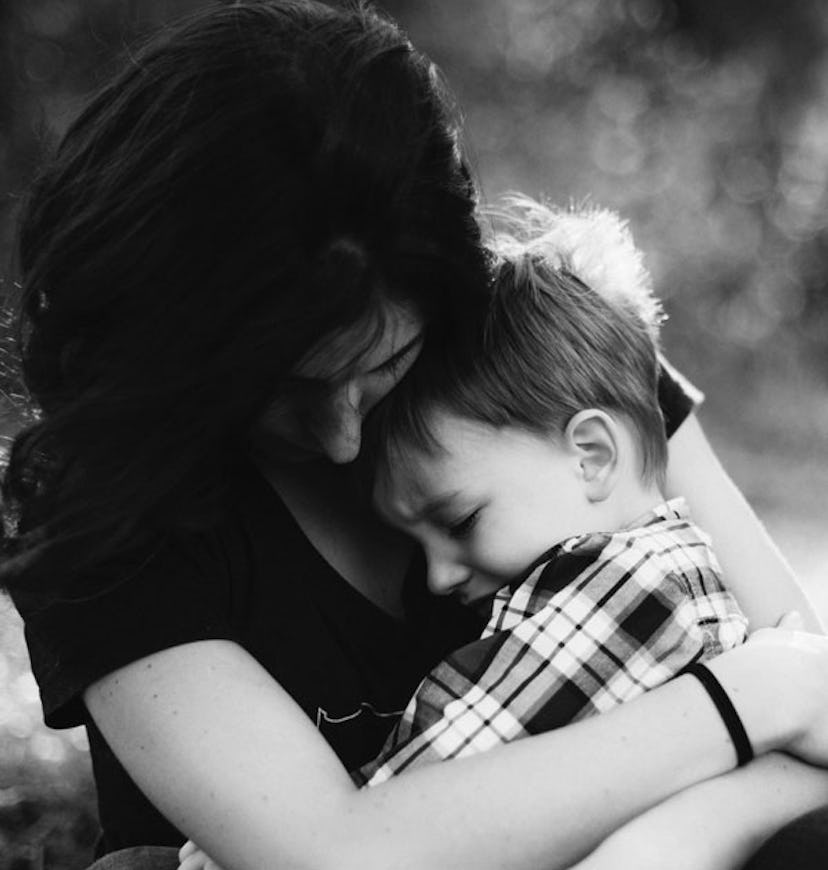 Mother holding her son that is crying