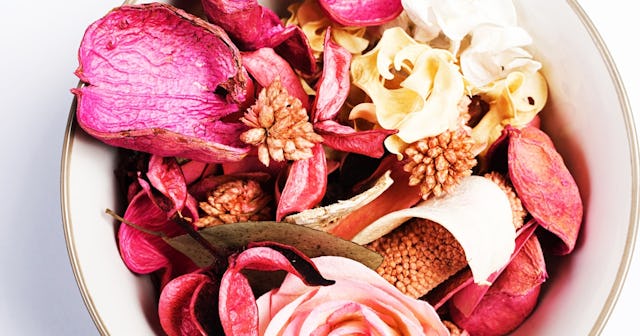Awhite bowl filled with pink and white potpourri alamy